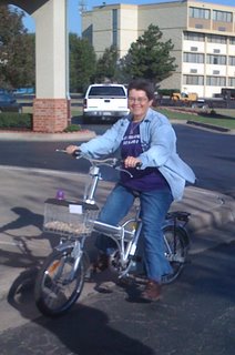 Ruth on an electric bike with gerbil