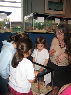 Melissa shows kids a tank of gerbils